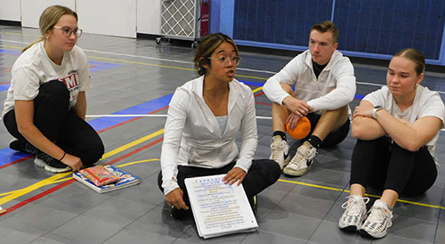 Instructors lay out the rules for students in the Barb City STEAM Team competing in activity.