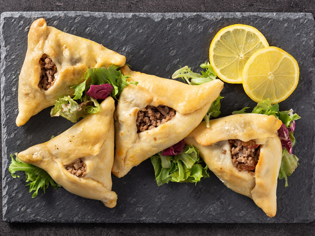 Traditional middle eastern fatayer on black slate background
